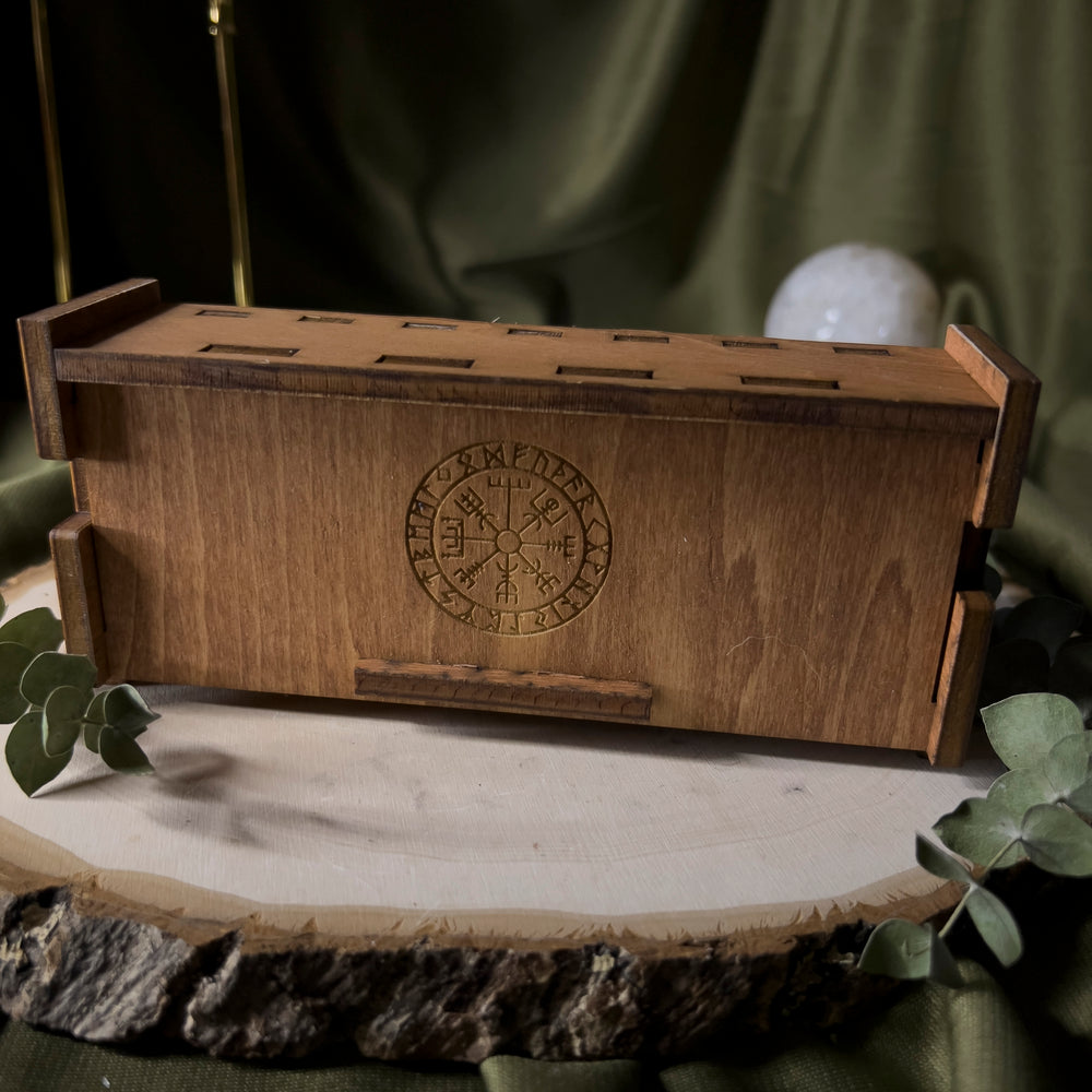 Light brown wood box with the vegvisir in the center.