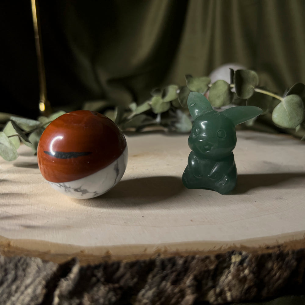 Green aventurine pikachu with a howlite and red jasper pokeball.