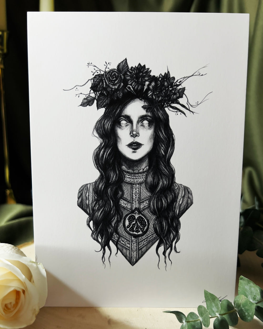 Art print depicting the goddess Persephone with florals in her hair and a pomegranate over her heart.
